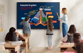 2 students are drawing some details about an volcanic eruption on a smartboard