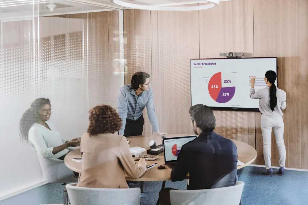 people disscussing in front of an interactive smartboard