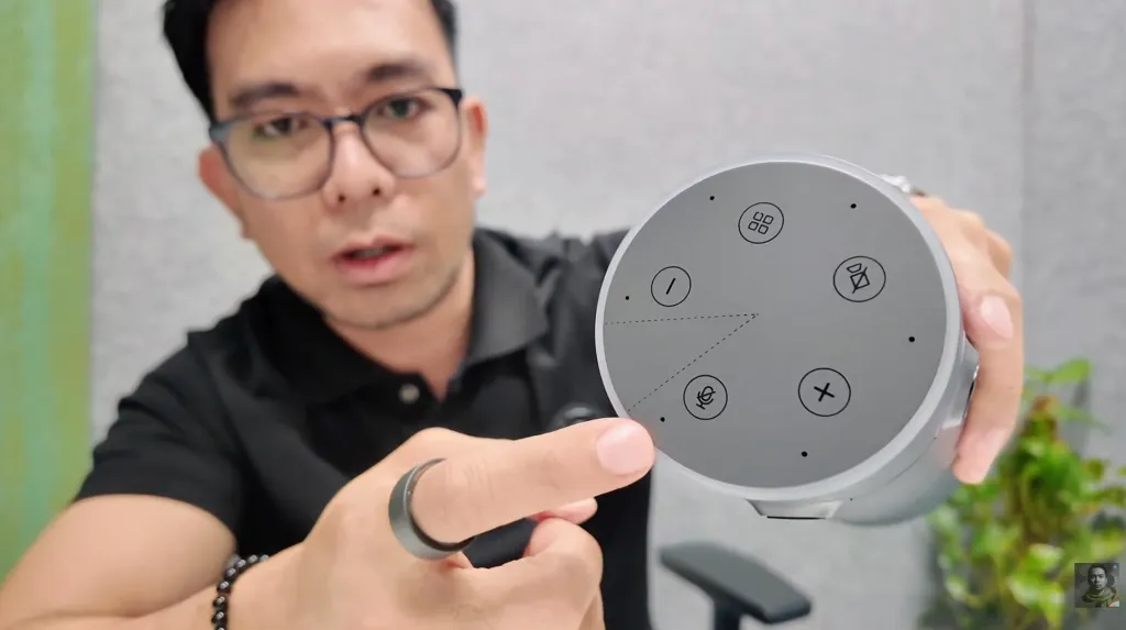 Tech reviewer Jeof demonstrating the five control buttons on the Nearity 360 Alien conference room camera