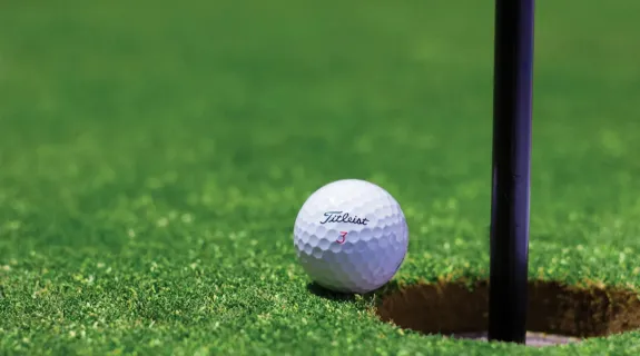 A golf ball near the hole