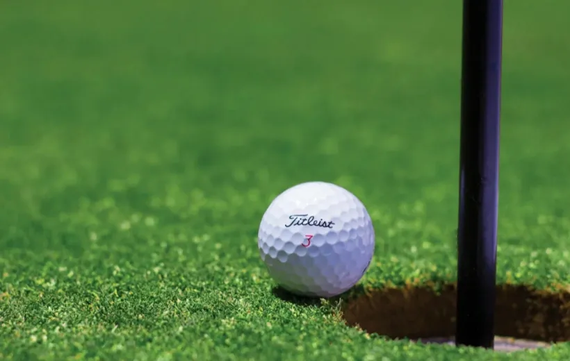 A golf ball near the hole