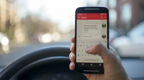 A person is messaging while in the car