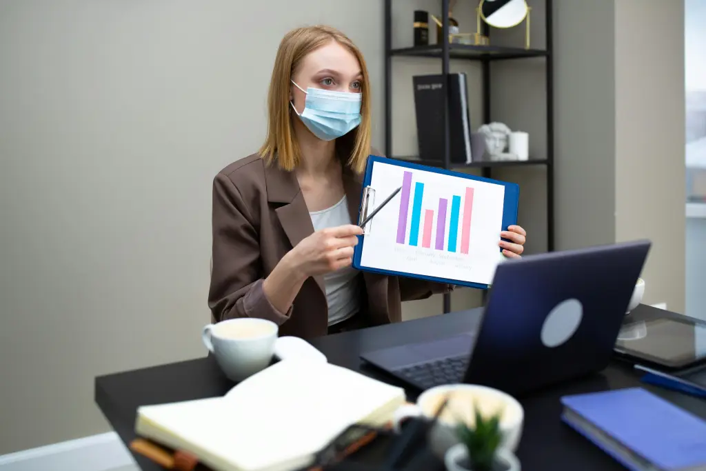 Eine Person praesentiert Daten waehrend eines Meetings auf einem Computer.jpg