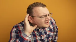 Man having difficulty hearing clearly