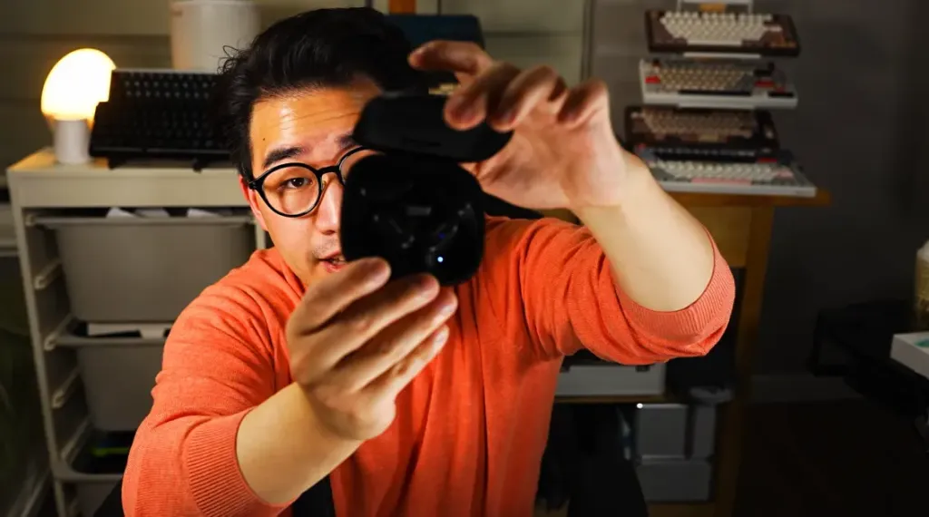 Mikey opening the Mempod Fit 2 case to prepare for a noise-cancellation test