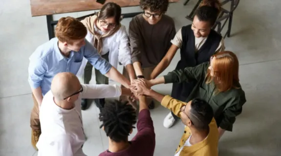 People started the morning standing meeting by holding hands together and cheering