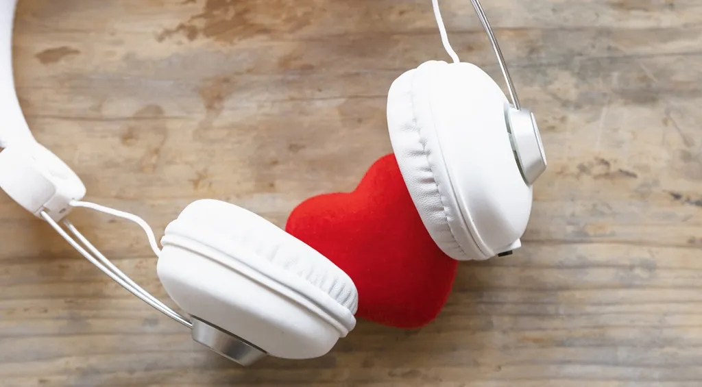 White headphones with a red heart representing comfortable and enjoyable listening