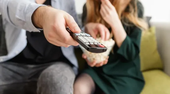 a man press the remote button
