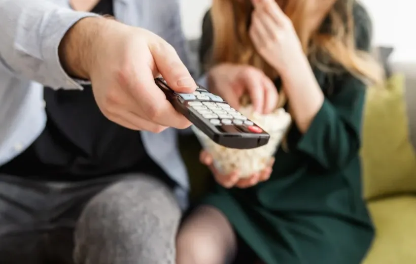 a man press the remote button