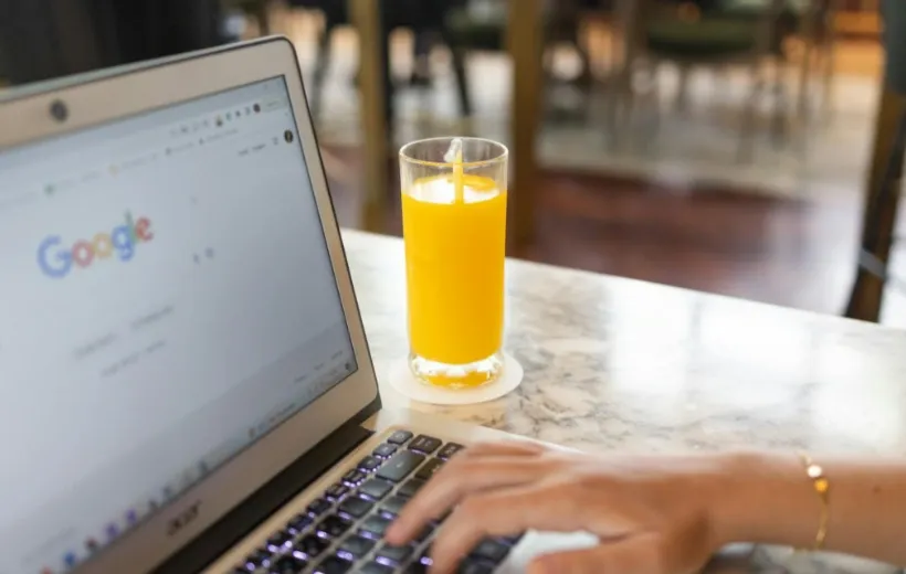 a women search something on the google with a orange juice