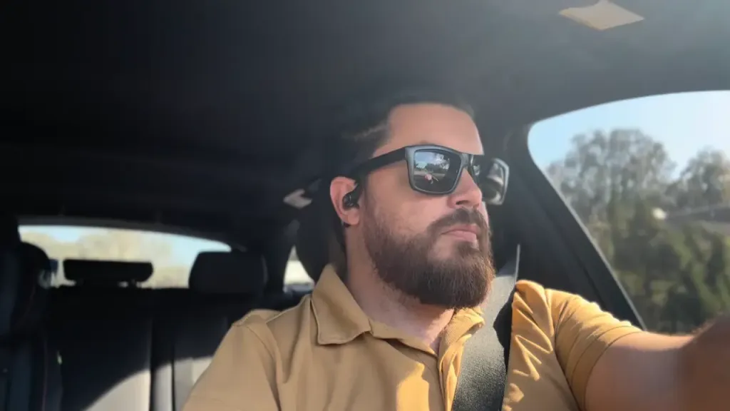 Brian wearing Mempod Fit 2 earbuds on his daily commute, enjoying clear, distraction-free sound while staying focused and safe.