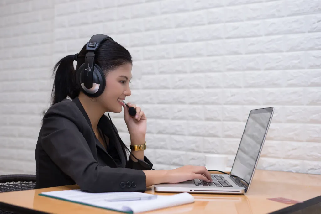 Young businesswoman wearing a USB headset while working at her desk in an office