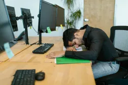 A man feels neck hurts sitting at desk
