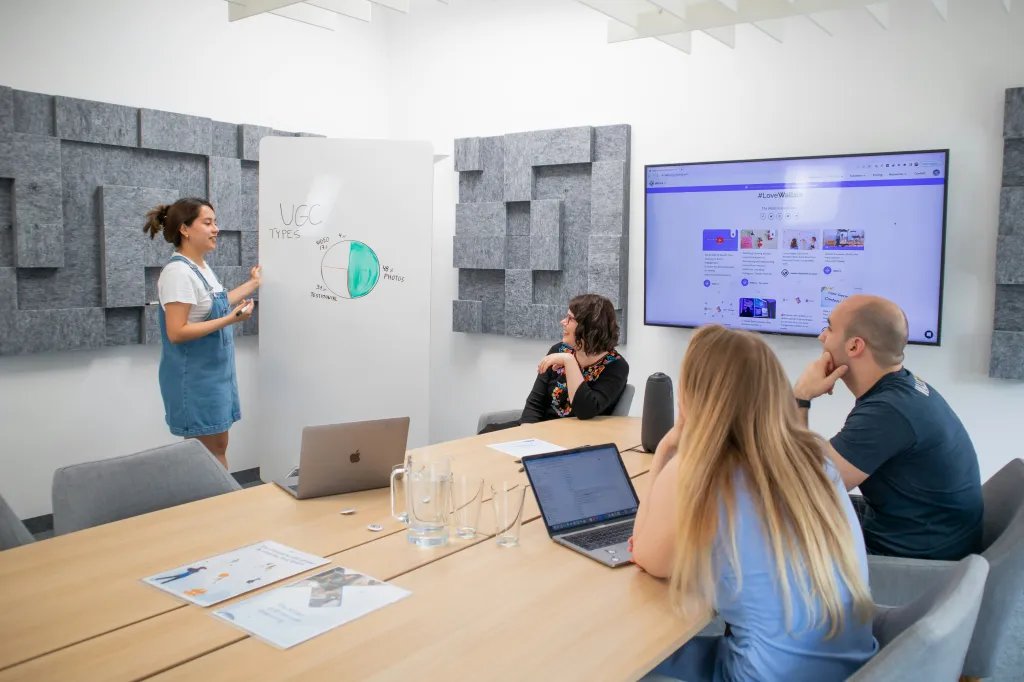 A professional smartboard wallpaper with a company logo displayed on a  board in a corporate meeting room