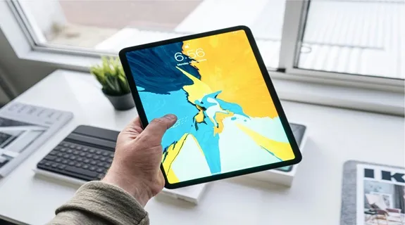 Der mann haelt ein ipad in der hand