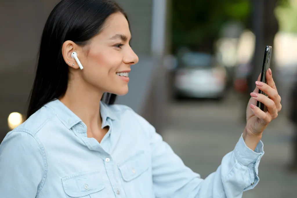 Woman wearing best earbuds for Android while commuting 2026