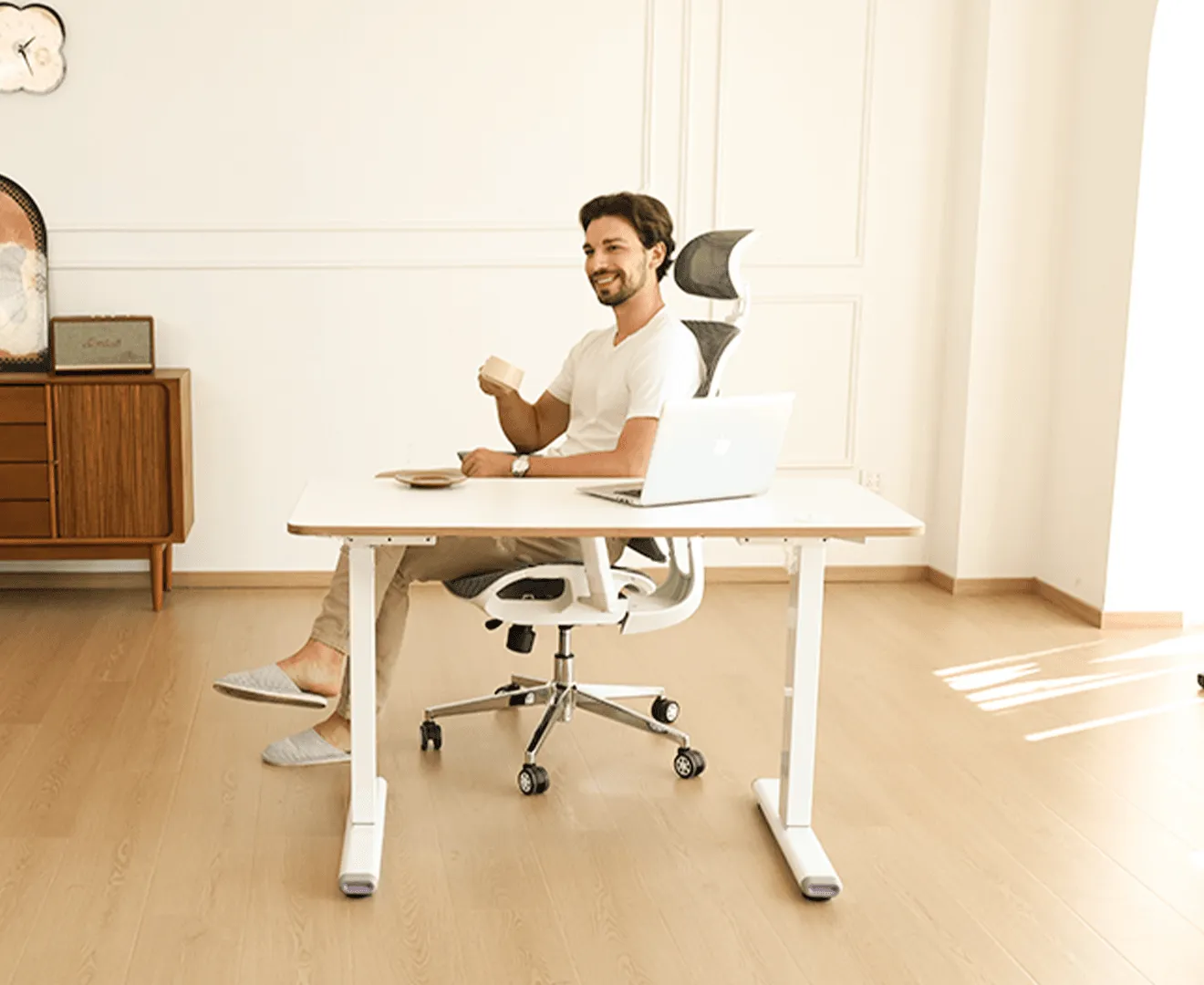 A man with a white dual motor sit stand desk