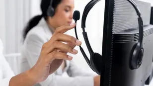 Remote professional wearing ENC headset during online meeting