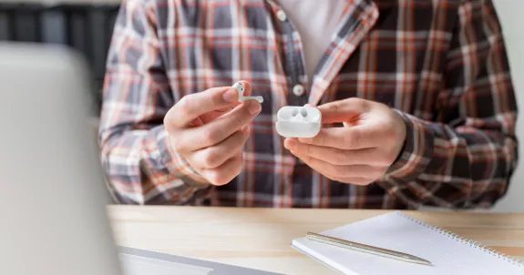 this man is thinking how to wear wireless earbuds correctly