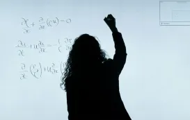 A teacher using a good whiteboard with smart technology to draw complex geometric shapes