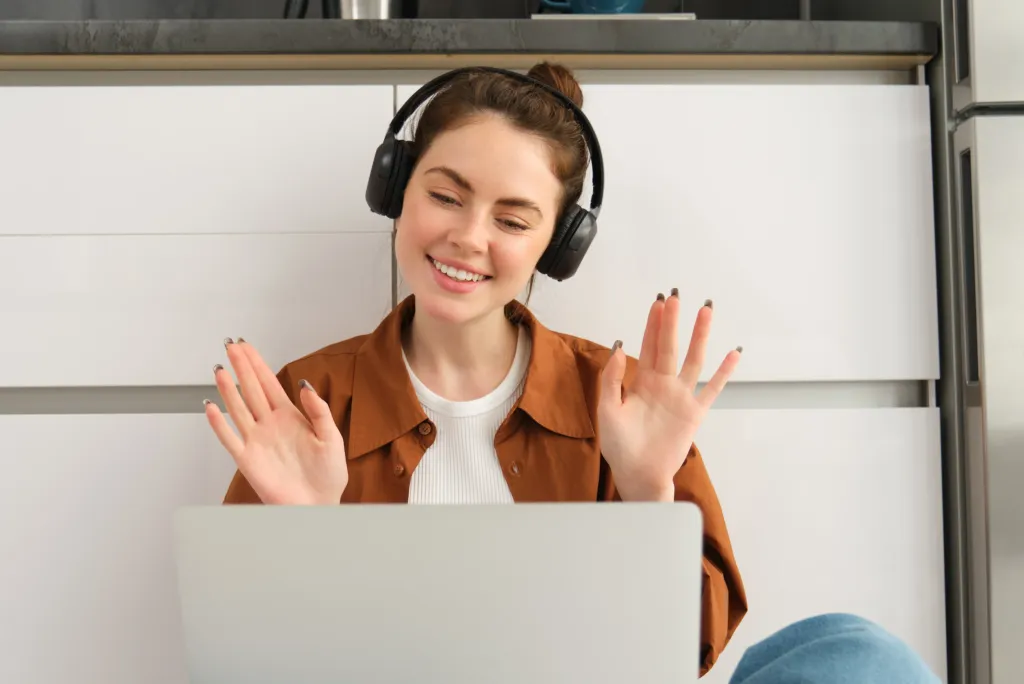 a fmale is sitting on the ground using best earbuds for call quality