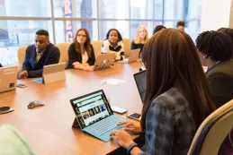 hybrid meeting long conference table laptop