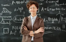 math teacher stands before a blackboard