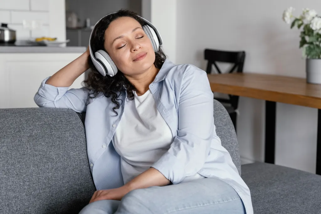 a sleeping woman is using best earbuds for team calls to listen to music