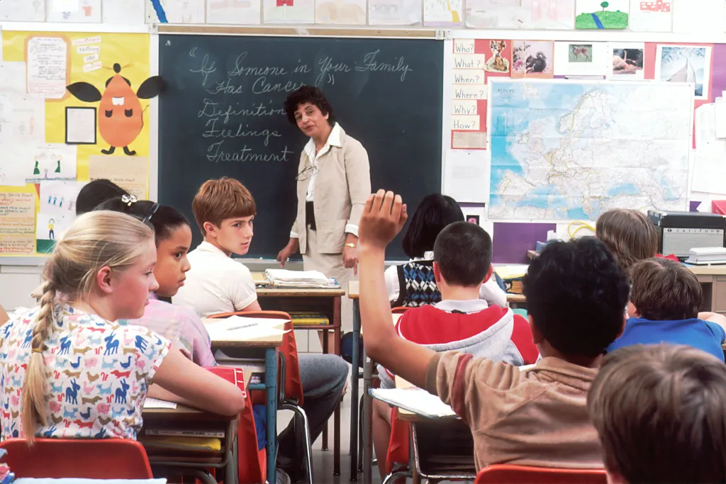 A science teacher shows students how do you use a smartboard 