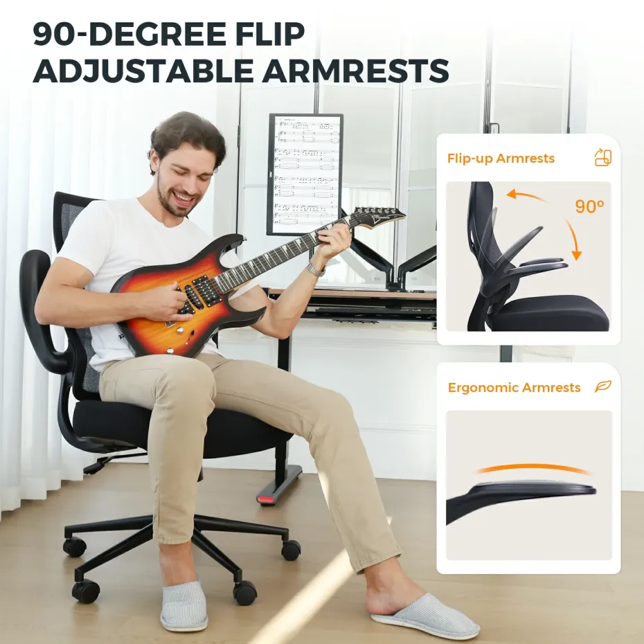 A man sits on a short desk chair