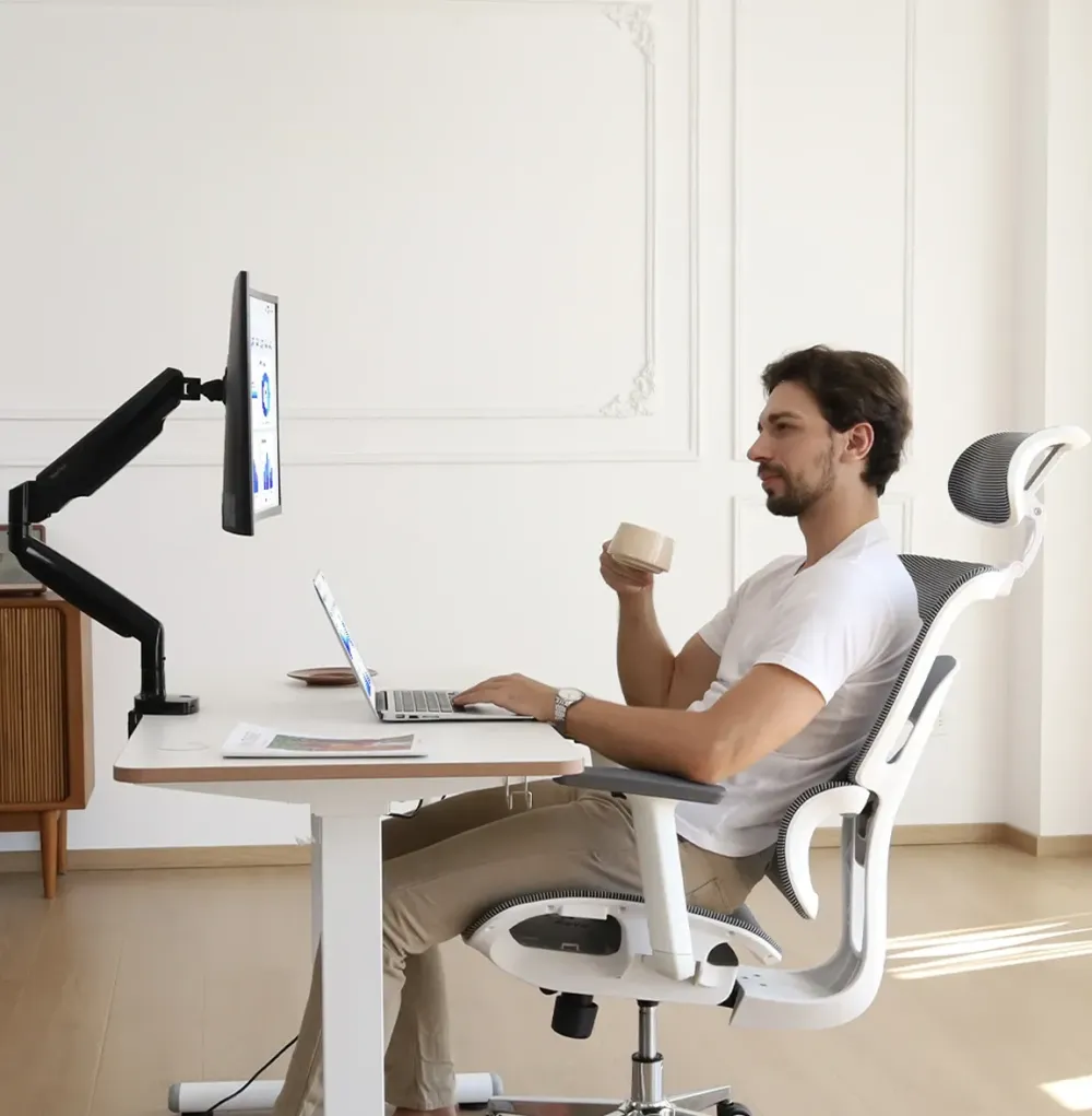 NearHub adjustable monitor stand with a desk and a chair in an office