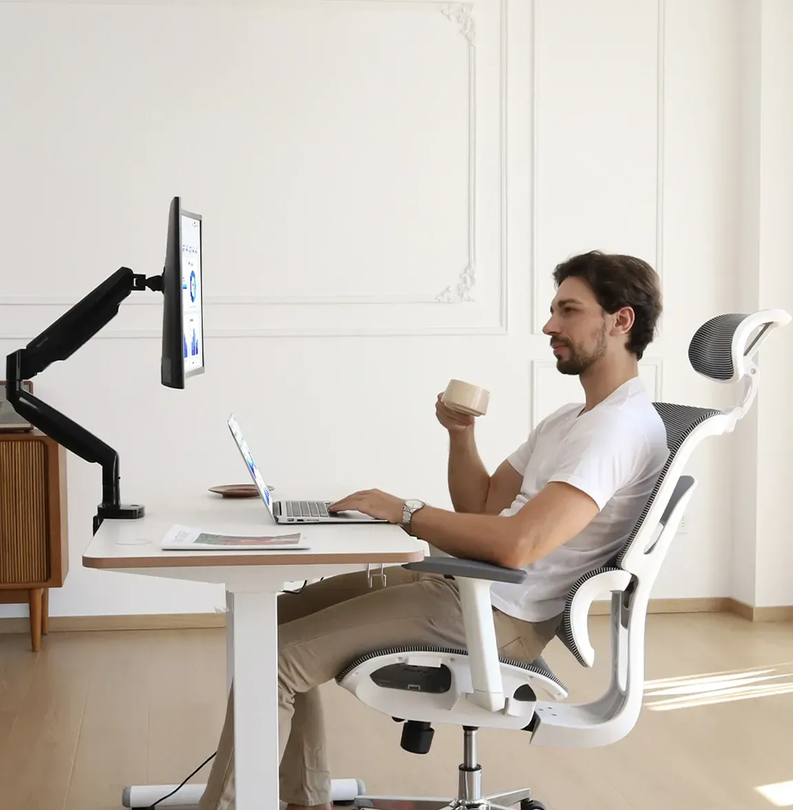 NearHub adjustable monitor stand with a desk and a chair in an office