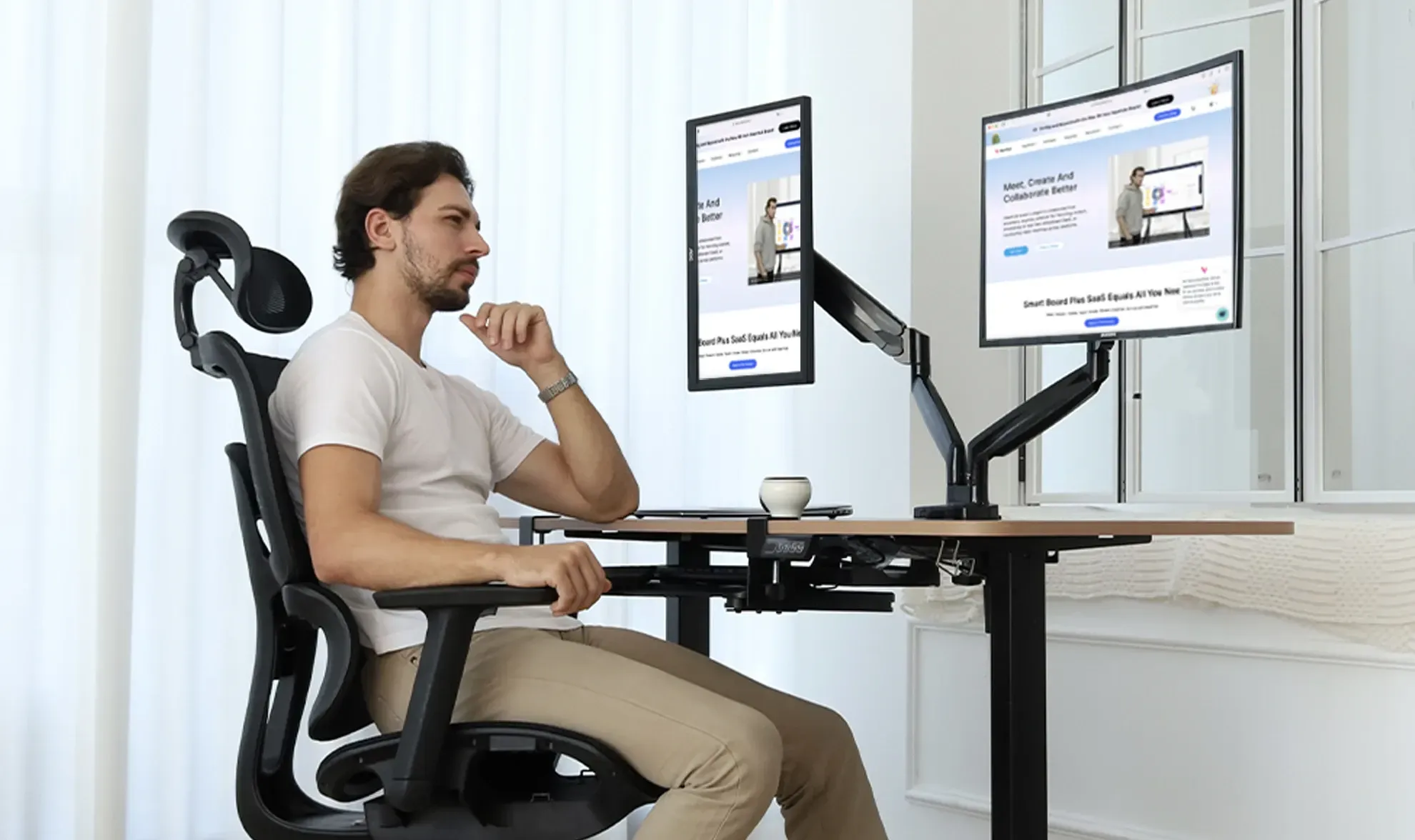 NearHub Ergo screen holders for desk MA40 with a man in front of two monitors