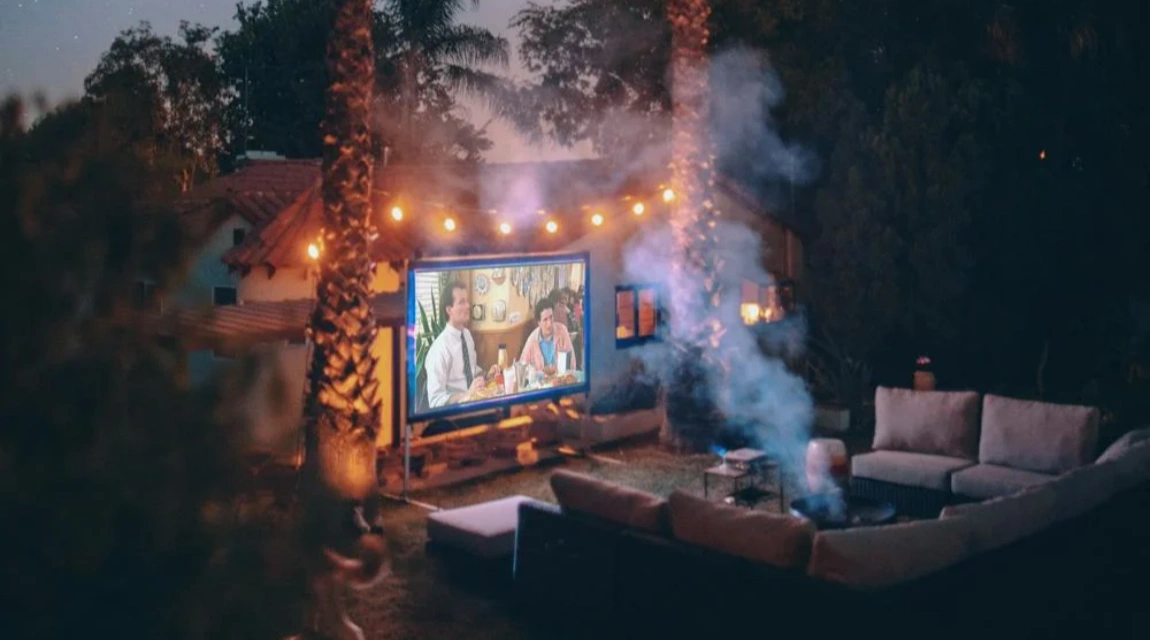 night projector in the outdoors which is below two coconut trees