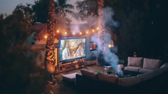 night projector in the outdoors which is below two coconut trees