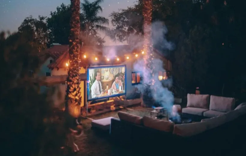 night projector in the outdoors which is below two coconut trees