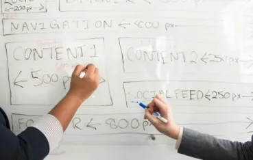 peopel writing on the whiteboard
