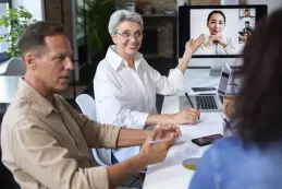 people using digital device while meeting