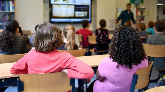a teacher using interactive whiteboard in the classroom