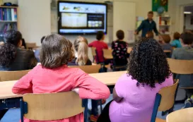 a teacher using interactive whiteboard in the classroom