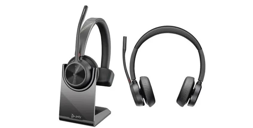A wireless business headset with an adjustable boom microphone, shown both on its desktop charging stand and from the front.
