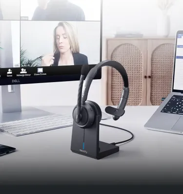 Close-up of a single ear headphone with mic docked on a charging stand during an online remote meeting, showing a practical one ear headset with mic.