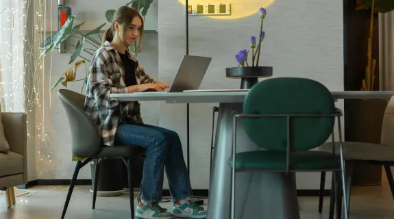 A woman sits on a good posture stool