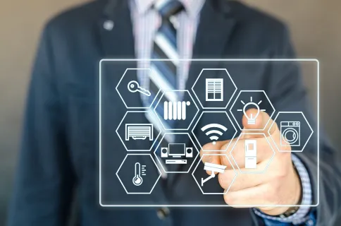 A professional using a touch screen interface as a central hub to control smart office systems and automation
