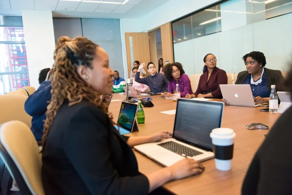 staff discuss something in the conference room.webp