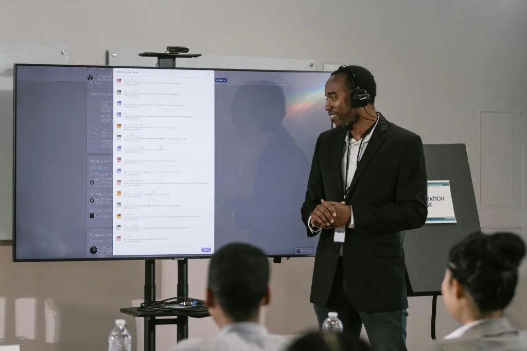 A group of engaged students working together on a  smart interactive whiteboard in a modern classroom
