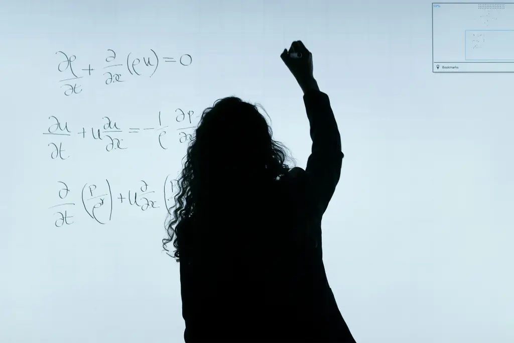 A teacher demonstrates how to use a smart board in her math classroom