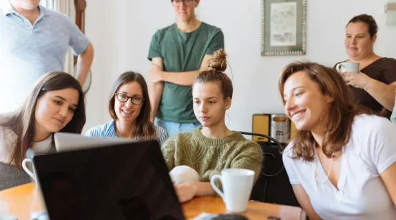 teachers gather in a conference room to discuss something