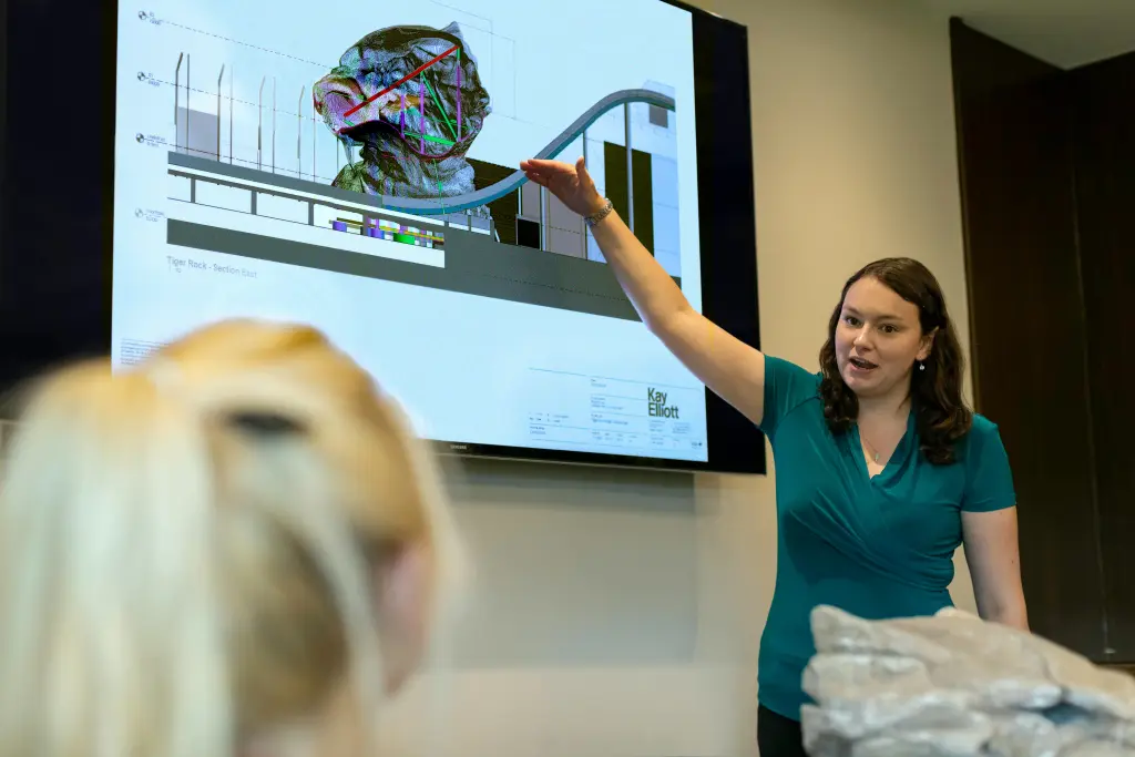 A diverse team brainstorming together and creating easy whiteboard drawings on a large  interactive whiteboard