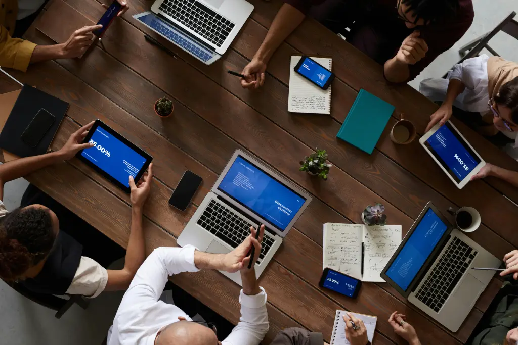A diverse team uses interactive screen software in a modern office